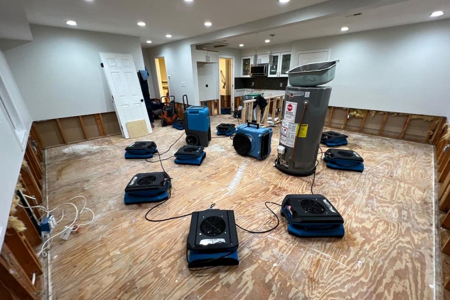 Air movers and a dehumidifier set up inside a BRG water damage project