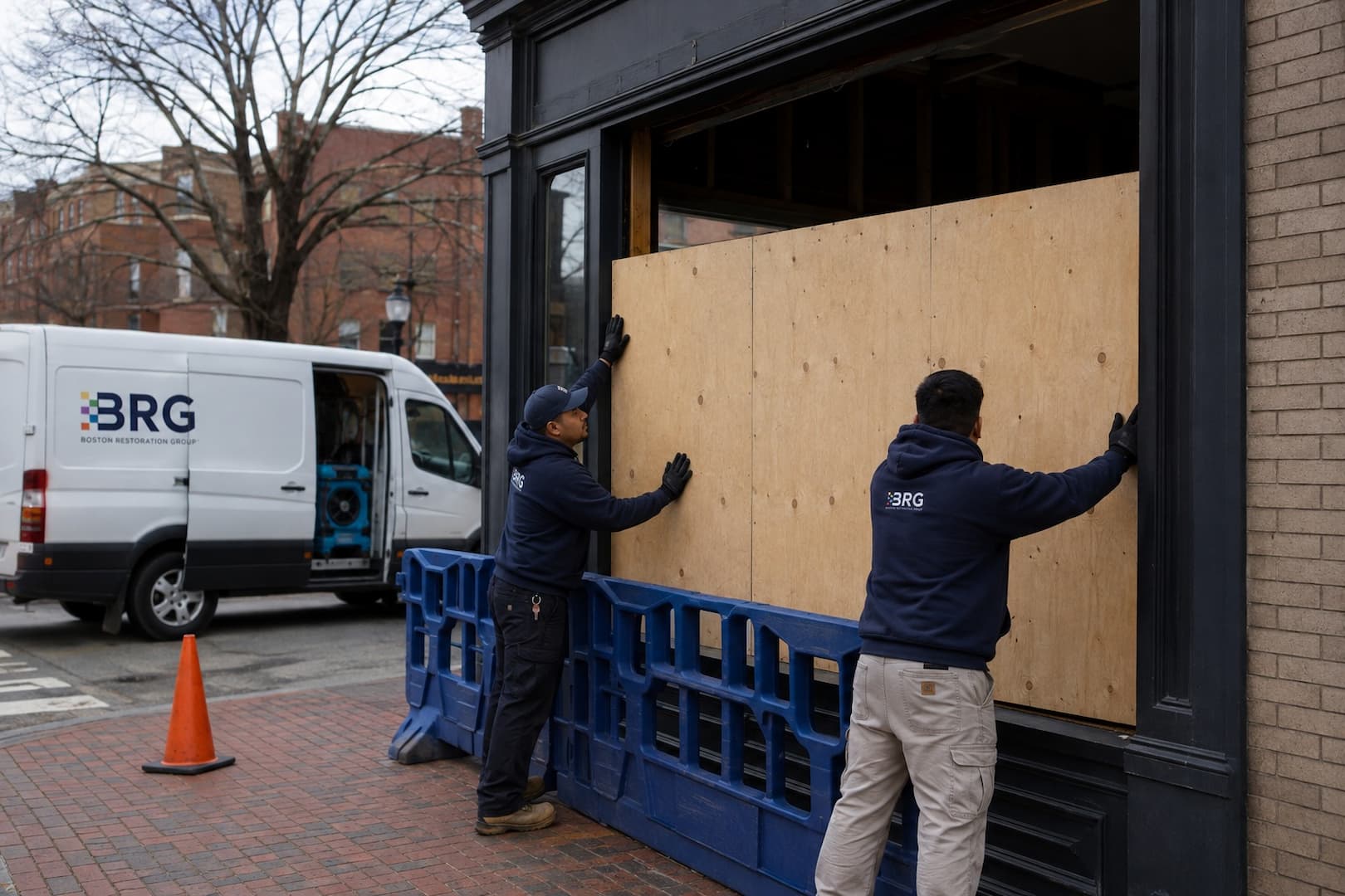 BRG crew protecting a storm-damaged window opening